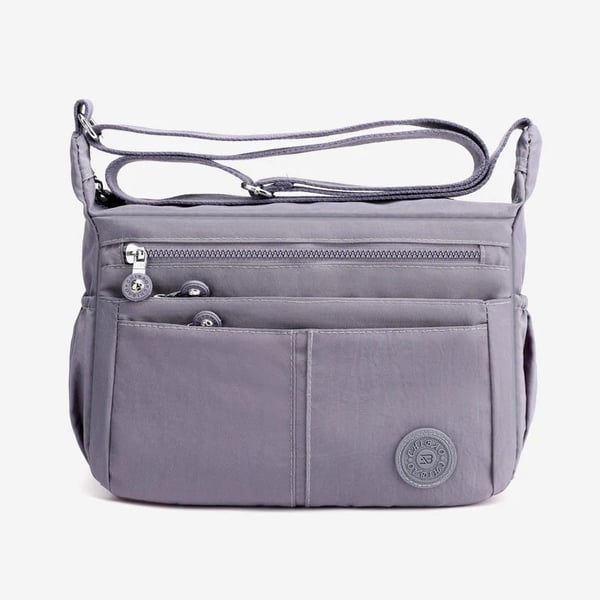 Bolso bandolera informal impermeable de gran capacidad y múltiples bolsillos.