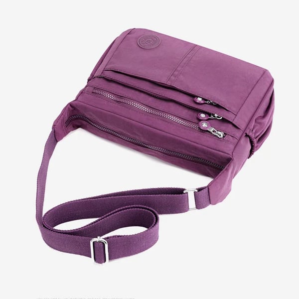 Bolso bandolera informal impermeable de gran capacidad y múltiples bolsillos.