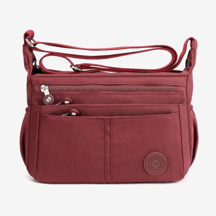Bolso bandolera informal impermeable de gran capacidad y múltiples bolsillos.